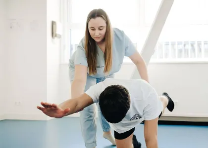 Fisioterapeuta guiando un ejercicio a un paciente